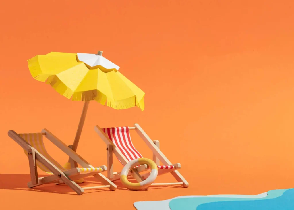 Imagem abstrata com o fundo laranja em uma praia, no qual apresenta duas cadeiras de praia e um guarda-sol amarelo no meio.